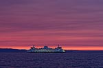A ferry crossing Puget Sound at sunset.  Seattle, WA.