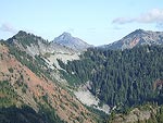 This is looking East.  The Pacific Crest Trail crosses through the trees on the right, and behind the tree covered peak to the left.