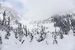 As we got near the end of the valley, the low clouds started to clear off a bit.  Snow Lake is up this slope, and then to the right.