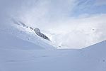 While we were making dinner, the clouds opened up a few times and we could see a little around us.  But we never did get a view of the summit.  This is looking across the Sulphide Glacier from camp.