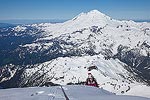 Brooke making the last part of the climb up the ridge onto the summit with Mt. Baker behind her.